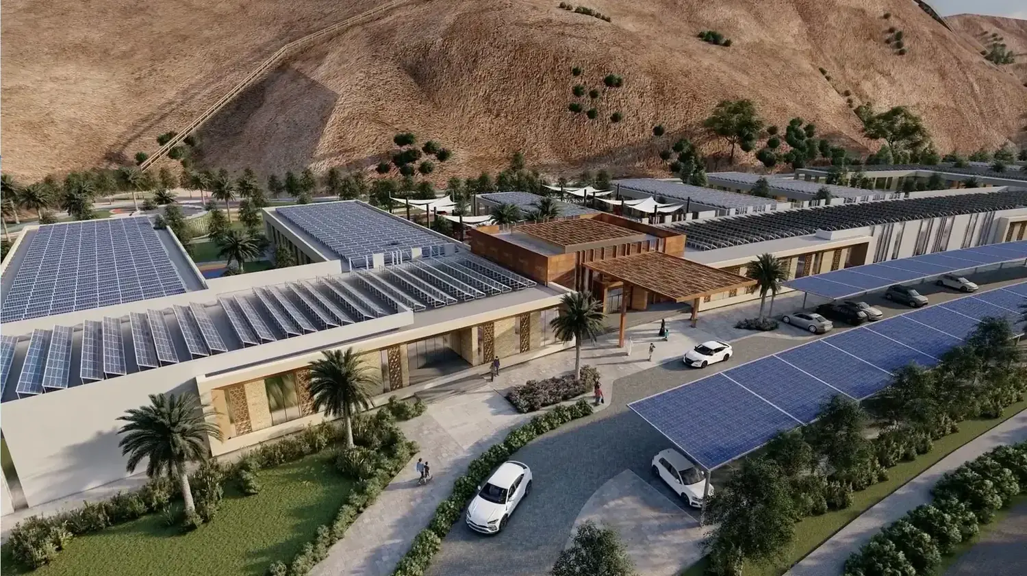 Aerial of solar shaded parking and rooftops generating power across the community